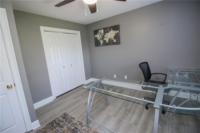 home office with ceiling fan and light hardwood / wood-style floors