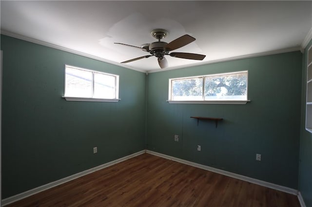 unfurnished room featuring ceiling fan, plenty of natural light, dark hardwood / wood-style floors, and ornamental molding