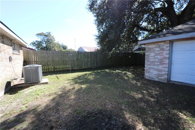 view of yard featuring central AC and an outdoor structure