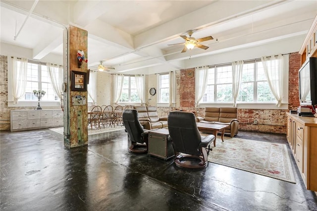 dining room featuring beam ceiling, ceiling fan, and brick wall