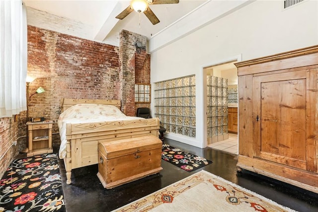 interior space featuring ceiling fan and brick wall