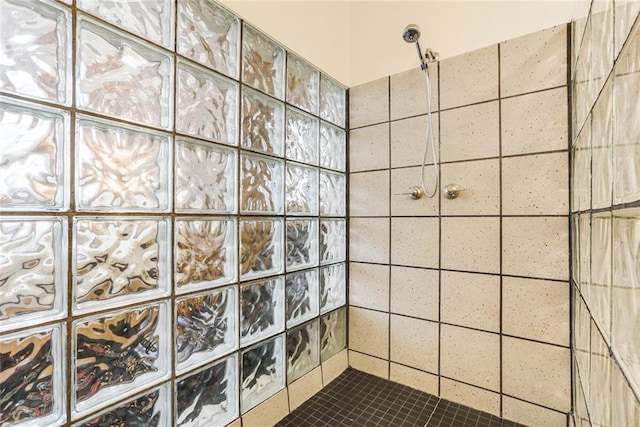 bathroom with a tile shower