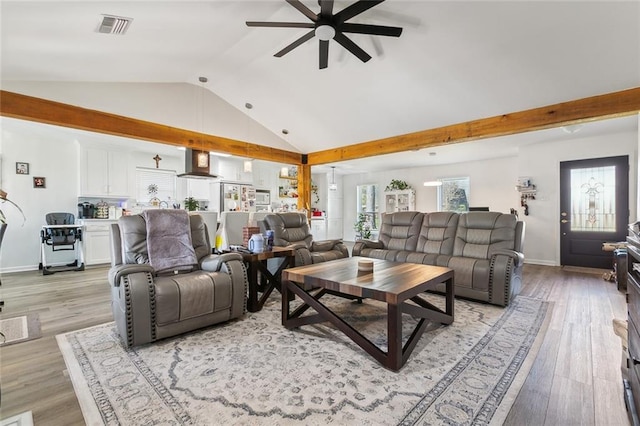 living room featuring ceiling fan, lofted ceiling, and light hardwood / wood-style floors