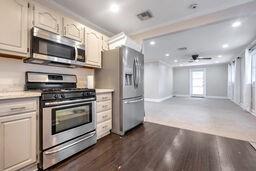 kitchen with ceiling fan, dark hardwood / wood-style flooring, and appliances with stainless steel finishes