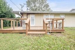 rear view of house featuring a lawn