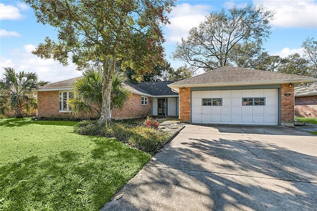 ranch-style home featuring a garage and a front lawn