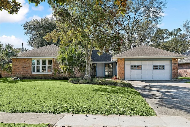 ranch-style home featuring a garage and a front lawn