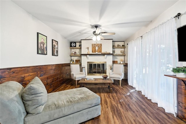 living room with ceiling fan, hardwood / wood-style floors, and a fireplace