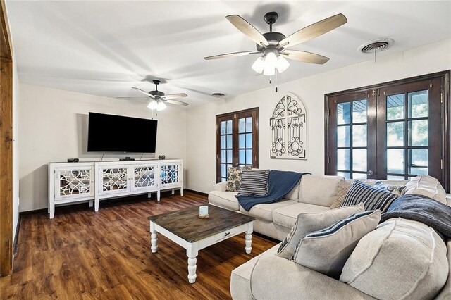 living room with hardwood / wood-style floors, a brick fireplace, and ceiling fan