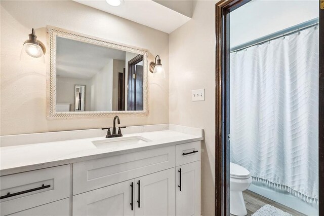 bathroom with hardwood / wood-style floors, vanity, and ceiling fan