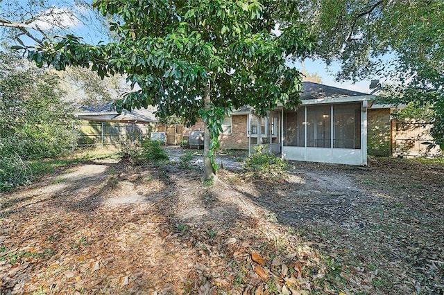 back of property with a sunroom