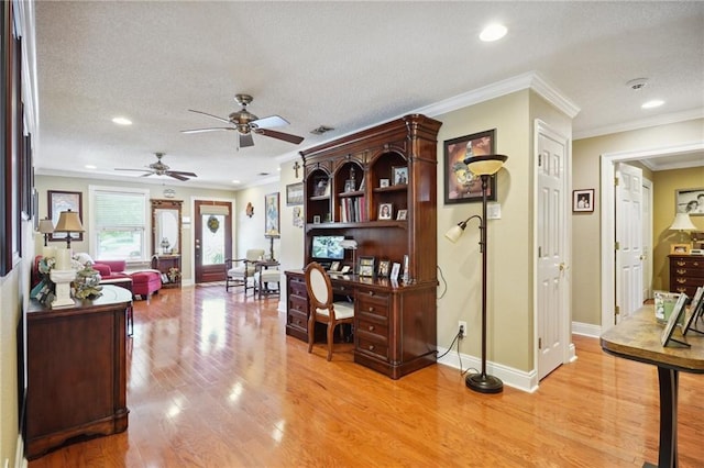 office area featuring ceiling fan, light wood-type flooring, ornamental molding, and a textured ceiling