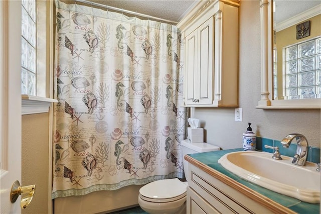 full bathroom with a textured ceiling, toilet, vanity, shower / tub combo, and ornamental molding