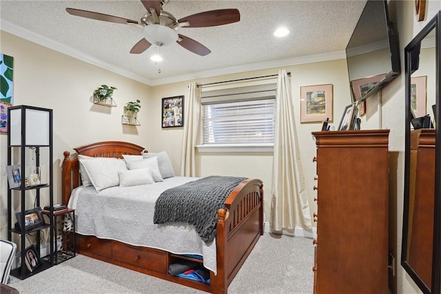 carpeted bedroom with ceiling fan, ornamental molding, and a textured ceiling