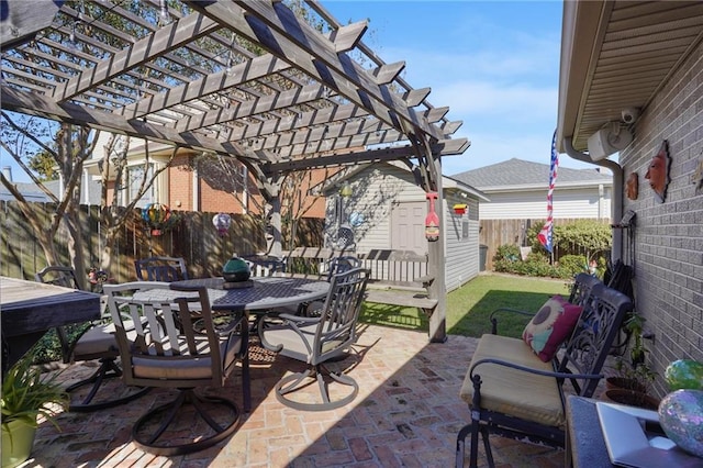 view of patio / terrace with an outbuilding and a pergola