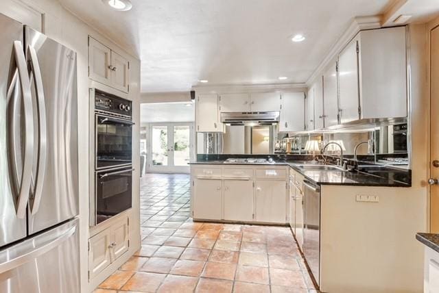 kitchen featuring white cabinets, sink, light tile patterned floors, and stainless steel appliances