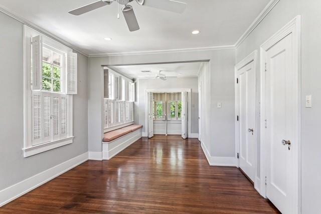 foyer with plenty of natural light, ceiling fan, ornamental molding, and dark hardwood / wood-style floors