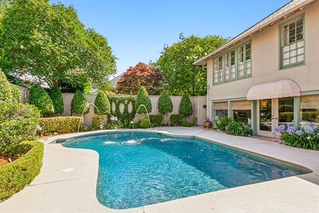 view of pool featuring pool water feature and french doors