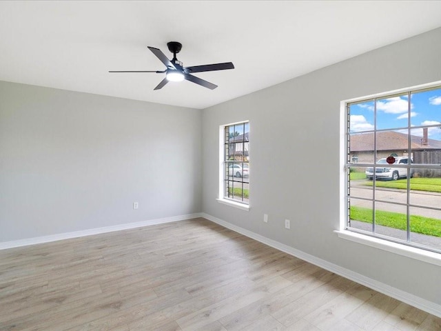 spare room with ceiling fan and light wood-type flooring