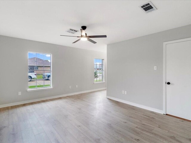 empty room featuring ceiling fan and light wood-type flooring