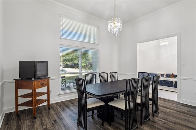 dining room featuring wood-type flooring, crown molding, and a notable chandelier