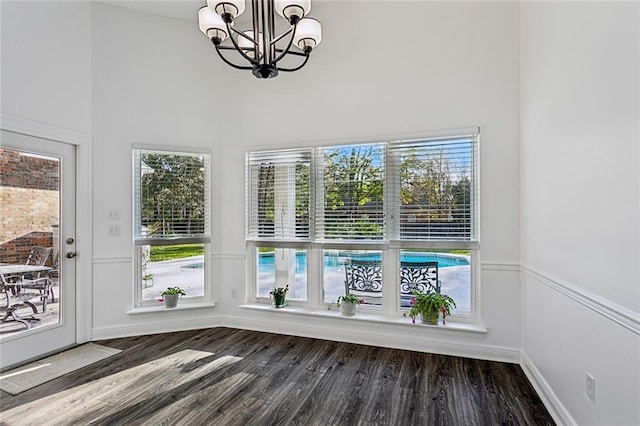 unfurnished sunroom featuring a notable chandelier