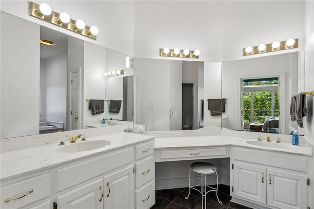 bathroom with tile patterned floors, vanity, and a bath