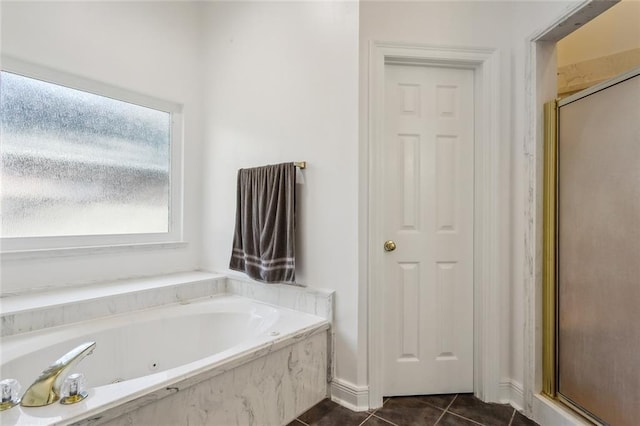 bathroom with tile patterned flooring and shower with separate bathtub