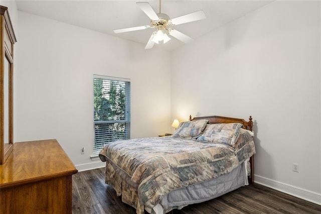 bedroom with ceiling fan and dark wood-type flooring