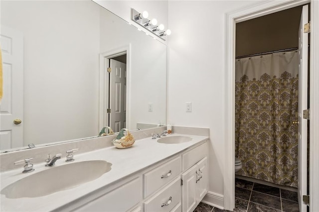 bathroom with tile patterned flooring, vanity, toilet, and walk in shower