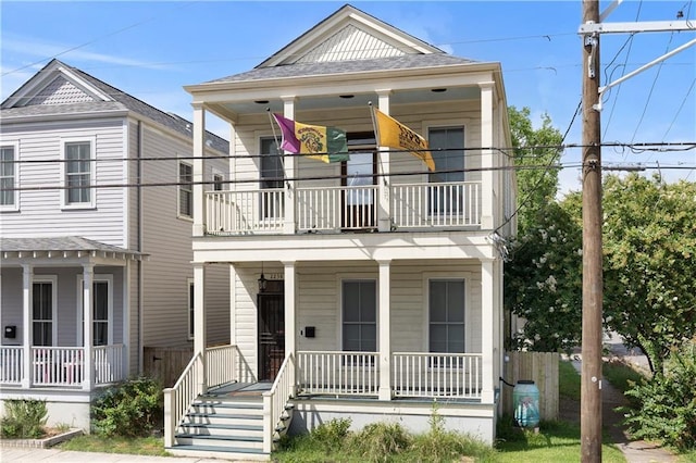 view of front facade featuring a balcony and covered porch