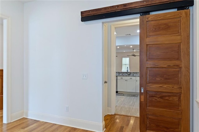 hall featuring sink and light wood-type flooring