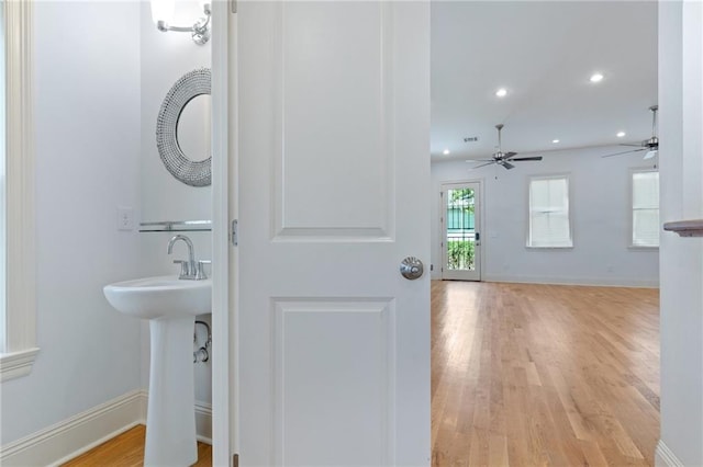 bathroom with ceiling fan and hardwood / wood-style flooring