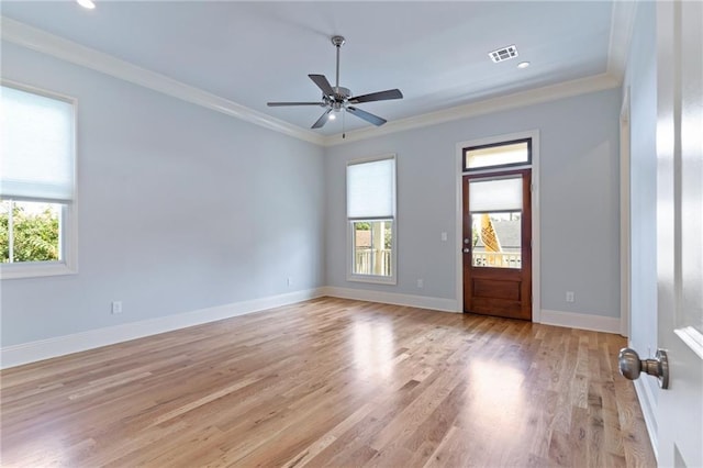 unfurnished room with crown molding, ceiling fan, a healthy amount of sunlight, and light wood-type flooring