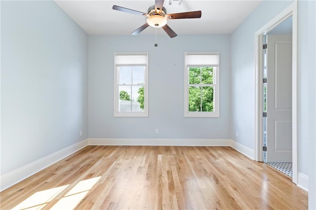 empty room featuring ceiling fan and light hardwood / wood-style flooring