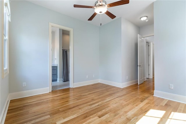 unfurnished bedroom featuring ceiling fan, light hardwood / wood-style floors, and ensuite bath