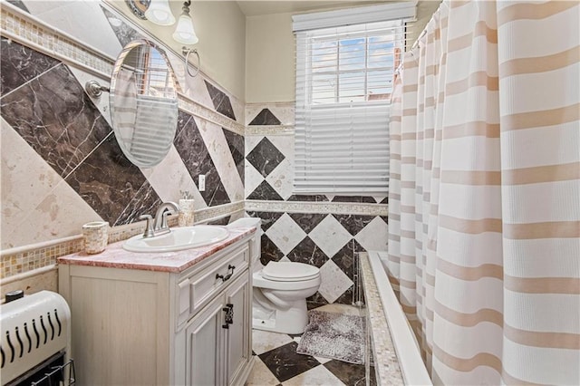 full bathroom featuring vanity, heating unit, shower / tub combo with curtain, tile walls, and toilet