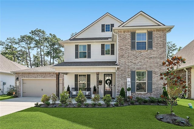 view of front facade with a front yard, a porch, and a garage