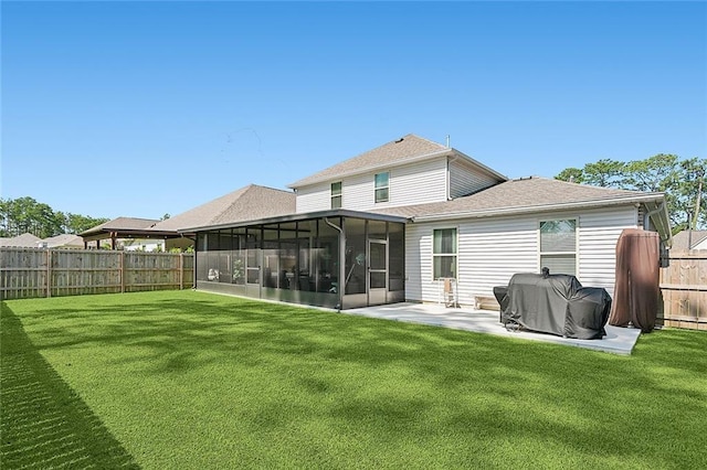 back of property with a yard, roof with shingles, a fenced backyard, and a patio area