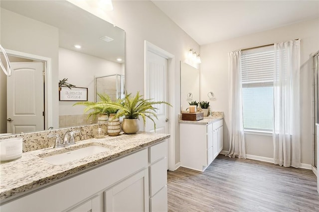 bathroom with vanity, wood-type flooring, and an enclosed shower