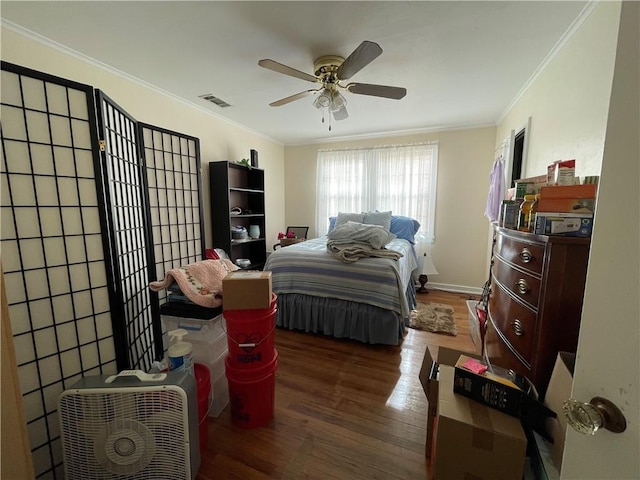 bedroom featuring ceiling fan, dark wood-type flooring, and ornamental molding