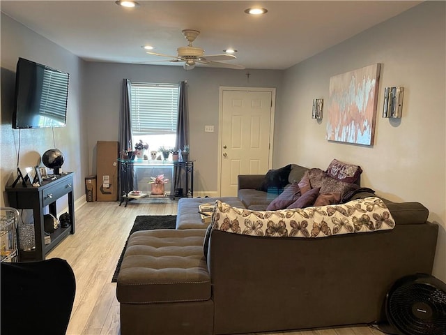 living room with ceiling fan and light hardwood / wood-style flooring