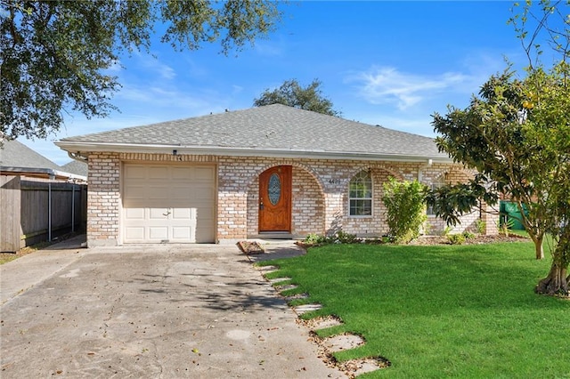 ranch-style home with a garage and a front lawn