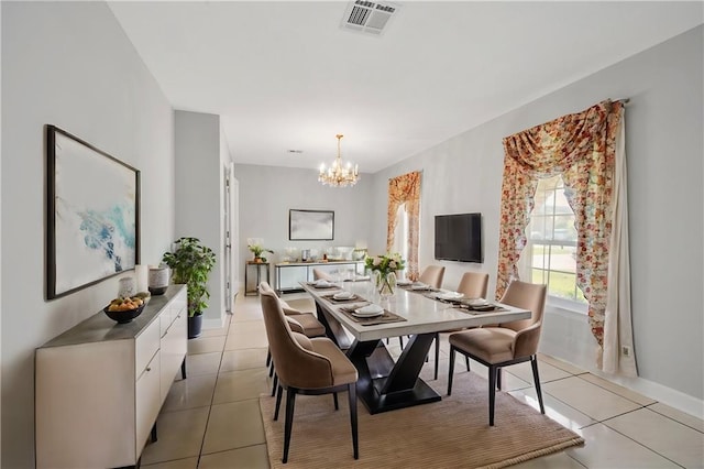 tiled dining space featuring a chandelier