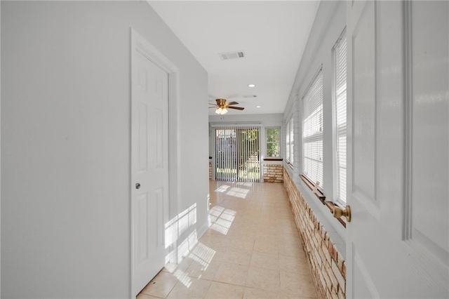 corridor featuring light tile patterned floors