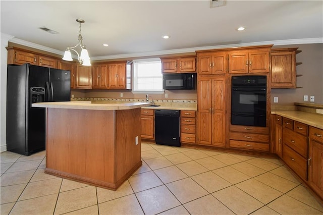 kitchen with pendant lighting, a center island, black appliances, ornamental molding, and light tile patterned floors