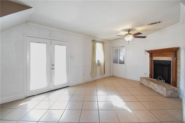 unfurnished living room with french doors, vaulted ceiling, ceiling fan, ornamental molding, and light tile patterned floors