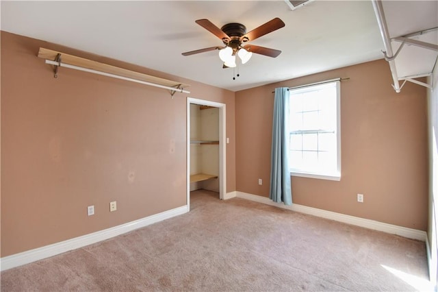 unfurnished bedroom with ceiling fan, light carpet, and a closet