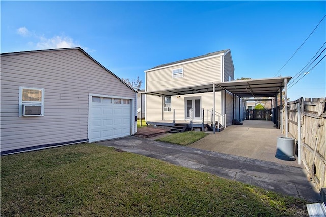 3000 Arlington St, Jefferson, LA 70121 - back of house featuring a garage, driveway, and an outbuilding