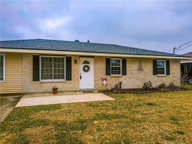 single story home featuring a patio area and a front lawn